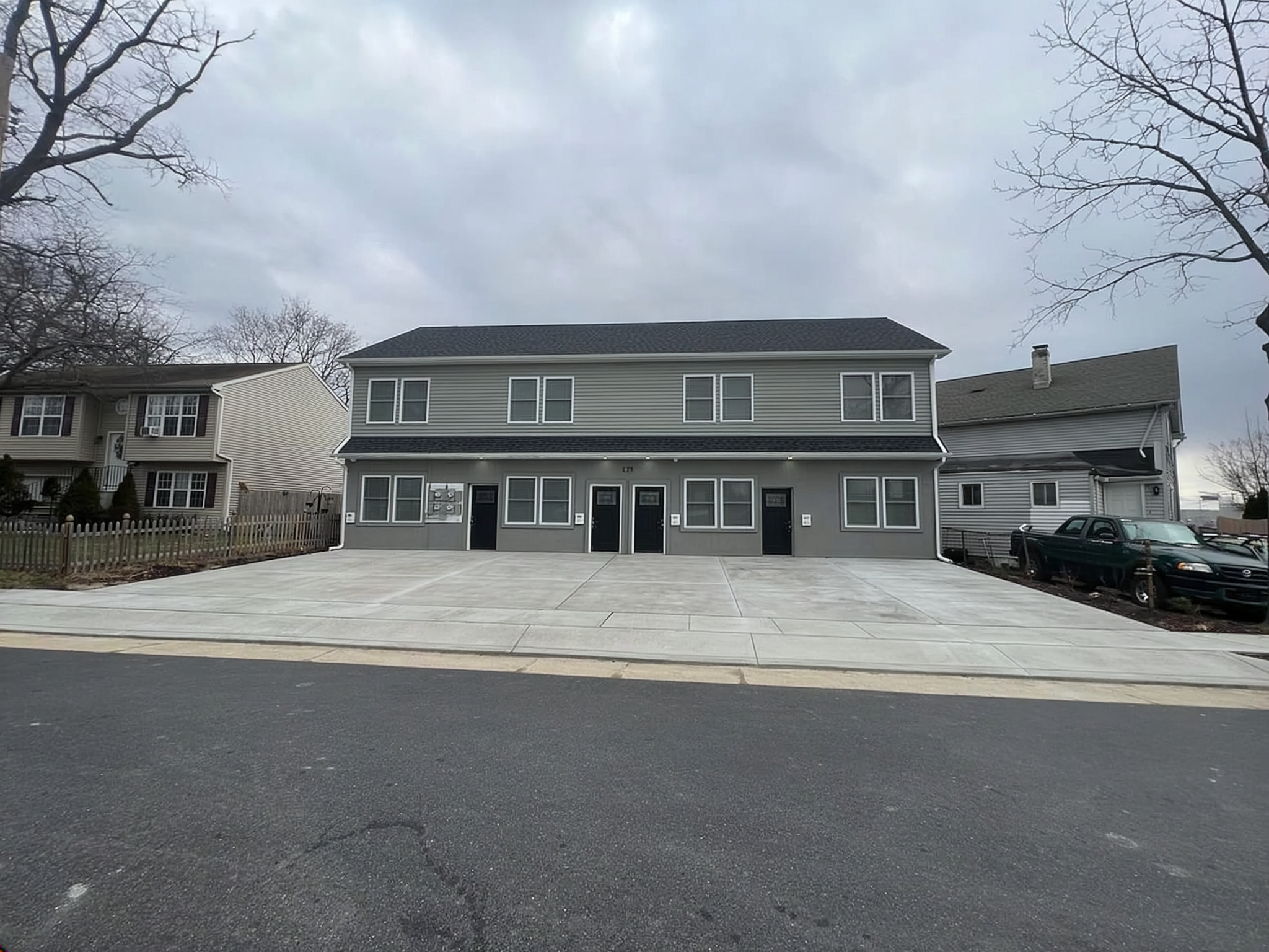 Completed 427 Salem Ave fourplex conversion exterior with four residential entries.